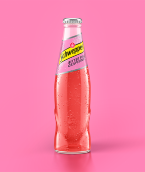Schweppes Bitter Pink Grapefruit als 0,2 Liter Flasche vor pinkem Hintergrund.